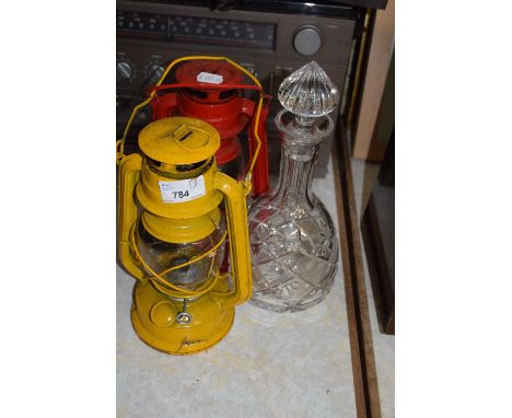Two paraffin lamps and a glass decanter