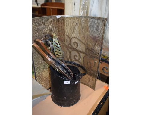 A curved spark guard together with a coal scuttle, bellows and fire irons and a gate