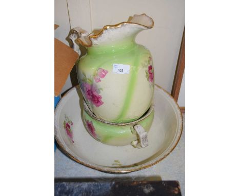 A green and floral glazed wash basin jug and chamber pot