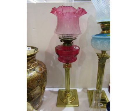 ANTIQUE OIL LAMP, brass column base cranberry glass reservoir oil lamp with floral acid etched cranberry tinted shade, 70cm h