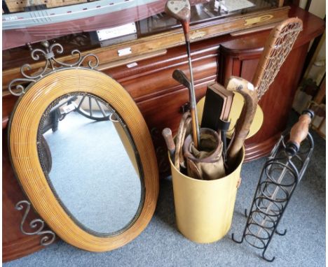 A freestanding cast metal wine rack, together with a decorative oval wall mirror and a selection of vintage sporting accessor