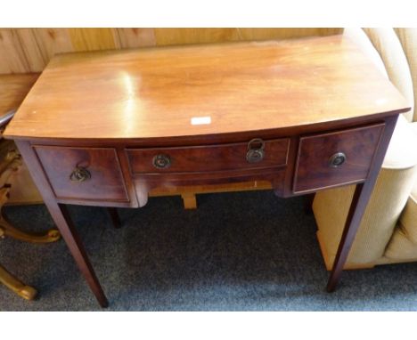 An early 20th century mahogany bow fronted knee hole side table, 86cm wide