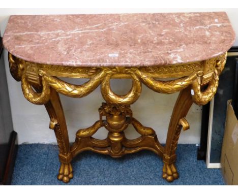 A marble topped bow fronted console table, with carved and pierced classical style gilt wood base, 102cm wide