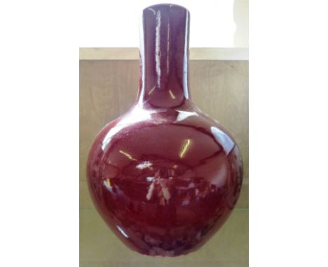 A glazed ceramic bulbous vase