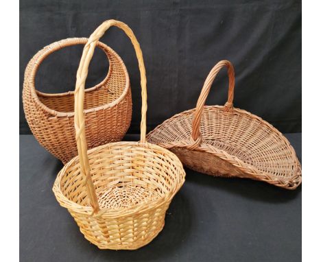THREE BASKETSconsisting of large trug, 52cm long; Gondola basket, 43cm high; and a display basket (3)