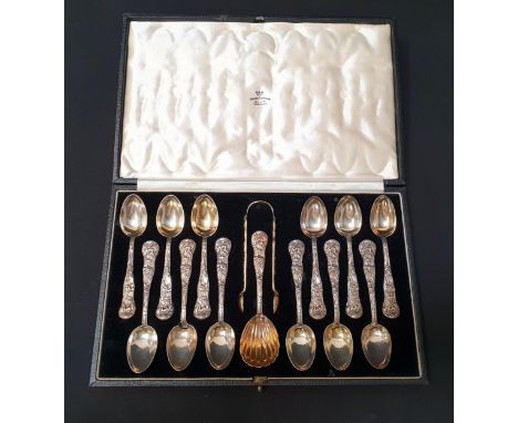 SET OF TWELVE VICTORIAN SILVER TEASPOONS,  SILVER GILT CADDY SPOON AND SUGAR TONGS BY H J LIAS & SONLondon 1871, embellished 