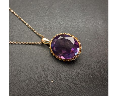 IMPRESSIVE AMETHYST SINGLE STONE PENDANTthe large oval cut amethyst measuring approximately 15 x 12 x 12.1mm, in unmarked gol