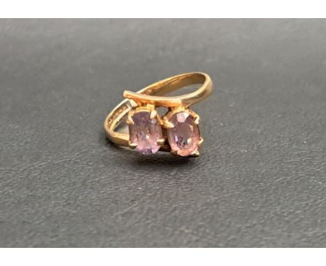 AMETHYST TWO STONE RINGthe two oval cut amethysts in twist setting, each gemstone approximately 0.75cts (1.5cts in total), in