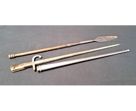 BAYONET WITH SCABBARDthe blade measuring 52cm; together with a metal spearhead on wooden shaft, 67cm long