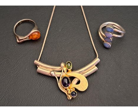 SELECTION OF GEM SET SILVER JEWELLERYcomprising a pendant with gold detail and set with cabochon peridot and amethyst, on sil