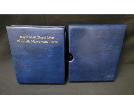 A ROYAL MAIL/ROYAL MINT ALBUM CONTAINING PHILATELIC NUMISMATIC COVERSin blue and gilt folder