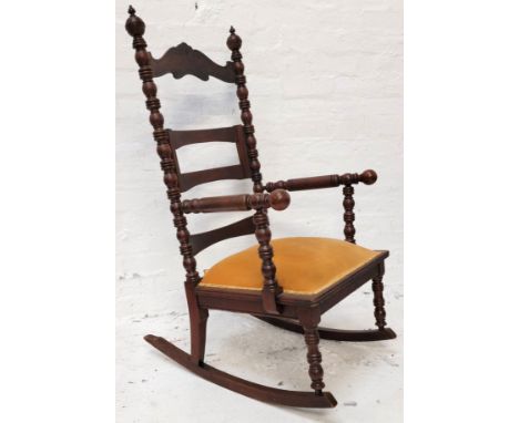MAHOGANY BOBBIN ROCKING CHAIRwith bobbin finials and rails, with apricot velvet upholstery