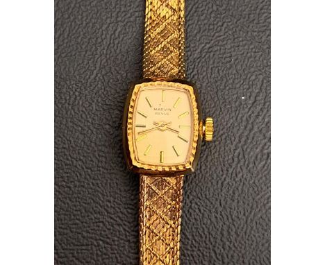 LADIES NINE CARAT GOLD MARVIN REVUE WRISTWATCHthe dial with five minute baton markers, on nine carat gold bracelet strap, tot