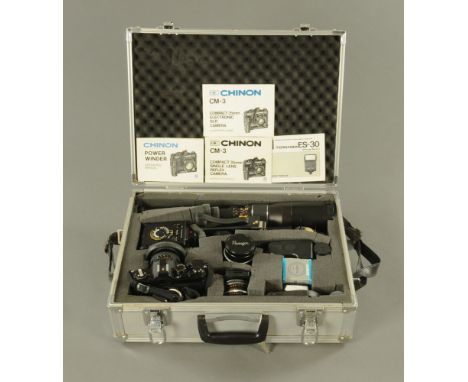 A vintage Chinon CN3 camera, together with lenses and metal case.