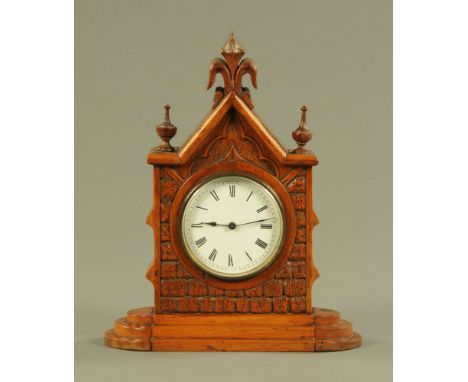 A late Victorian Gothic walnut mantle clock, with single train movement.  Height 27 cm, width 22 cm.