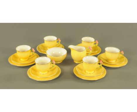 An Art Deco Royal Winton tea set, with foliate handles and yellow glaze. CONDITION REPORT: There are hairline cracks to one s