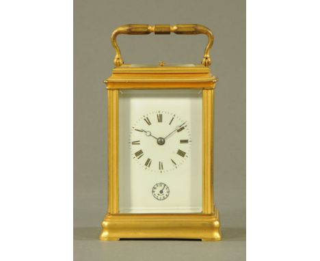 A brass carriage clock, with repeat mechanism and alarm.  Height excluding carrying handle 14 cm.