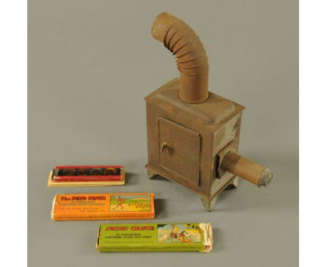 A Vintage child's magic lantern, together with a quantity of Disney slides.  Lantern height 26 cm.