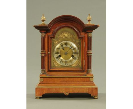 An Edwardian walnut and brass mounted mantle clock, with two train spring driven movement.  Height 36 cm, width 28 cm, depth 