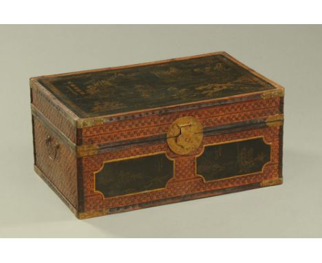 A Chinese lacquered trunk, metal bound and with applied panels.  Height 36.5 cm, width 79 cm, depth 50 cm. CONDITION REPORT: 
