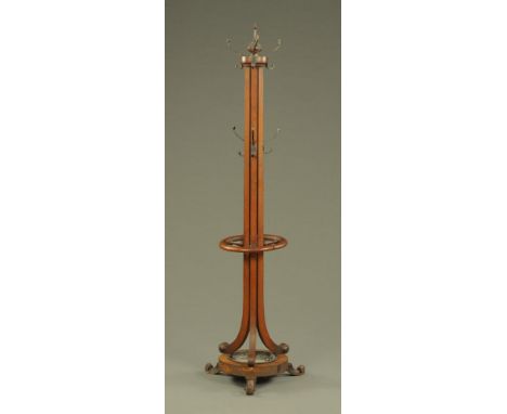 An early 20th century hat and coat stand, mahogany, with circular base and drip tray and raised on scrolled feet.  Height 190