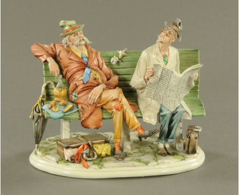 A Capodimonte figure group, figures on a bench by Tiziano Galli.  28 cm.