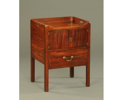 A George III mahogany commode cabinet, with single aperture carrying handle to either side and with cupboard over the commode