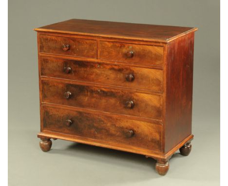A 19th century mahogany chest of drawers, two short over three long with wooden knob handles and raised on bun feet.  Height 