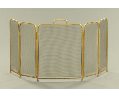 A folding spark guard, brass, comprising five sections.  Height including carrying handle 61 cm, combined panel width 124 cm.