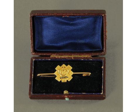 A 15 ct gold Highland Light Infantry sweetheart brooch or tie pin, in original case.  5.25 grams.