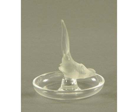 A Lalique pin and ring holder, in the form of a bird with circular base etched Lalique France.  Height 10.5 cm, diameter 9.5 