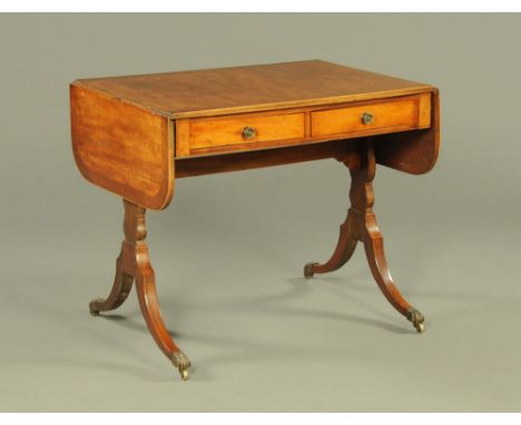 A 19th century mahogany crossbanded sofa table, fitted with two frieze drawers and two opposing dummy drawers with silhouette