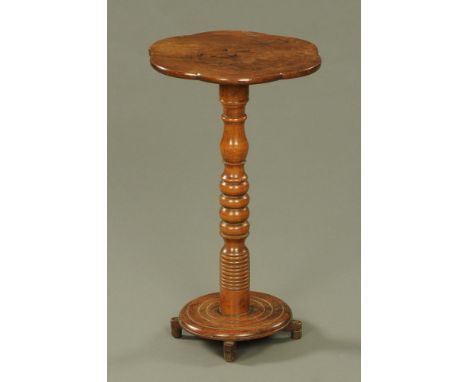 A 19th century Welsh mahogany occasional table, with shaped top turned column and circular base raised on toupie feet.  Heigh