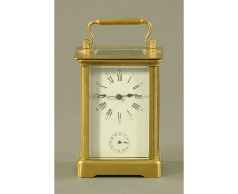 A French brass carriage clock, with alarm.  Height 11 cm excluding carrying handle.