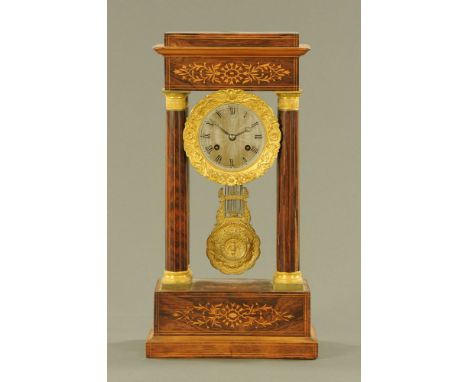 A 19th century French rosewood and inlaid portico clock, with two train striking movement.  Height 50 cm, width 26 cm, depth 