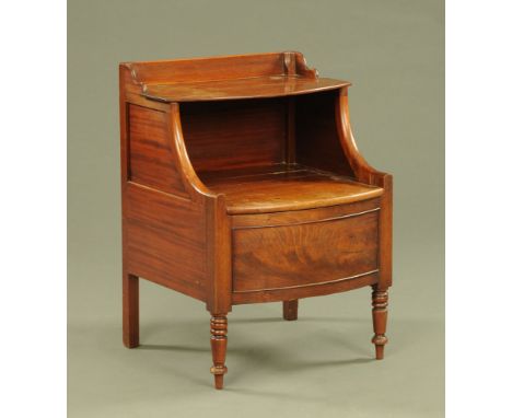 A late Georgian mahogany bowfronted commode, with shelf and furnished interior and raised on turned legs.  Height 78 cm, widt