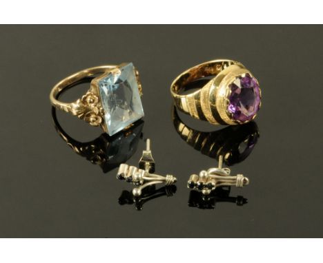 A 9 ct gold ring, set with an amethyst coloured stone, together with a 333 gold stamped ring set with a blue stone and a pair