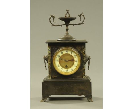 A late Victorian black slate and marble mantle clock, with urn finial with single train movement and raised on splayed bracke