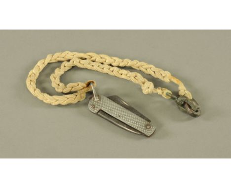 A vintage Naval clasp knife and lanyard.
