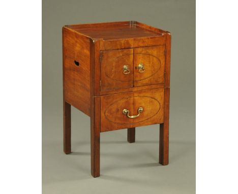 A George III mahogany commode cabinet, with tray type top above a pair of doors with brass handles and with commode drawer be