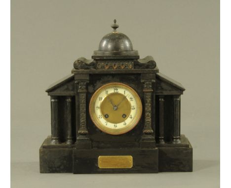 A Victorian black slate mantle clock, with two train striking movement.  Height 34 cm, width 34.5 cm.