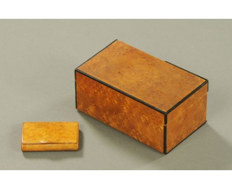 A burr wood snuff box.  Length 8.5 cm, together with a birds eye maple box.  Length 17.5 cm.