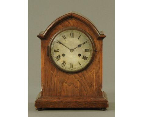 An Edwardian inlaid oak mantle clock, with two train spring driven movement.  Height 35 cm, width 24 cm, depth 14 cm.