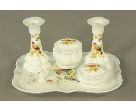 A Czechoslovakian Victoria china dressing table set, comprising tray, candlesticks, ring stand and two lidded containers.