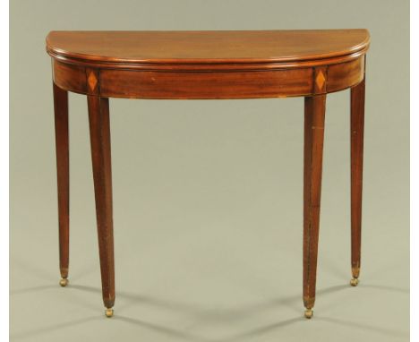 A George III mahogany turnover top tea table, with moulded edge and recessed frieze and raised on tapered legs of square sect