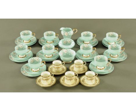 An Aynsley tea service, comprising 10 cups, 10 saucers, 10 plates, 2 sugar basins and milk jug, rose patterned with glue grou