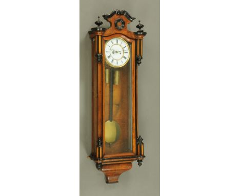 A Victorian walnut and ebonised twin weight Vienna type regulator wall clock, with two train movement.  Height 109 cm, width 