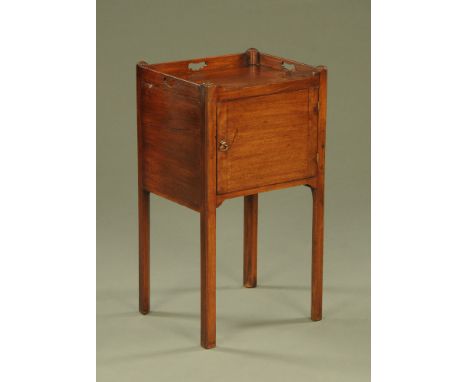 A George III mahogany bedside cabinet, with tray type top and carrying apertures with single door and raised on moulded legs.