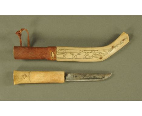 A vintage Lapland Scrimshaw handled knife, with Scrimshaw scabbard.  Overall length 27 cm.