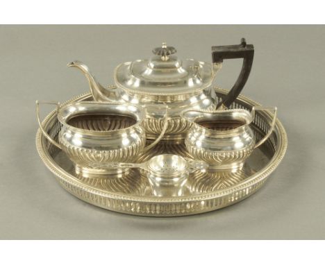 A Victorian three piece silver plated tea service, together with a tray and tea strainer.